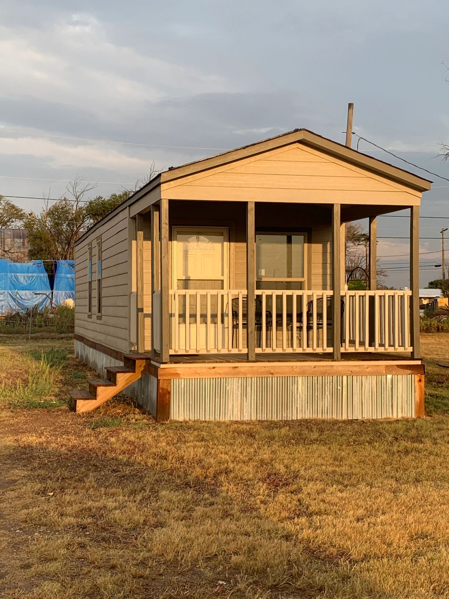 Tiny cabin with a covered front porch.